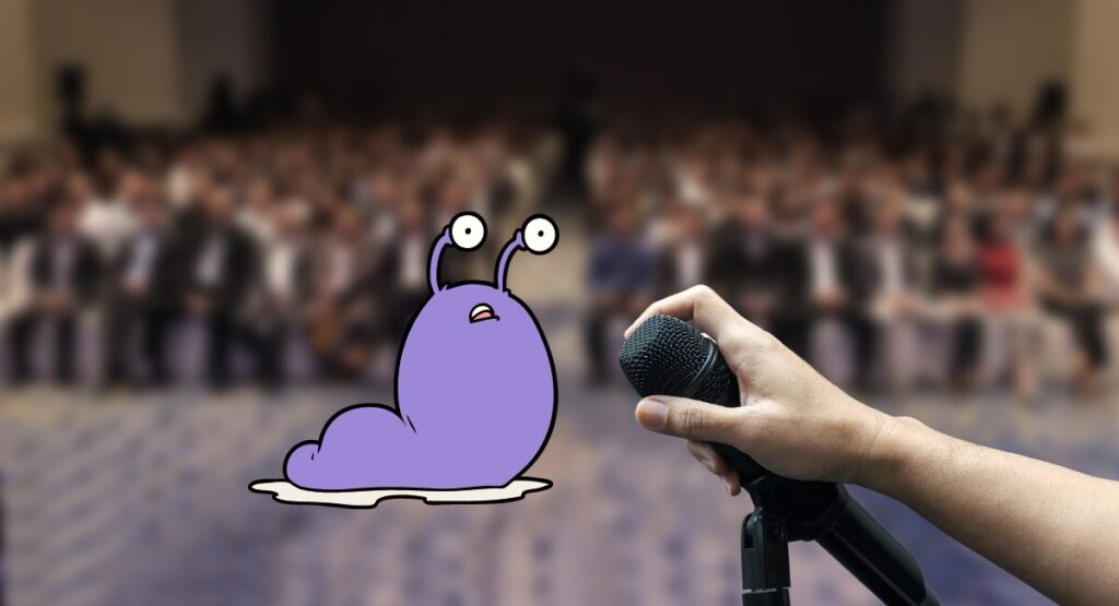 A slug by a microphone in front of an audience